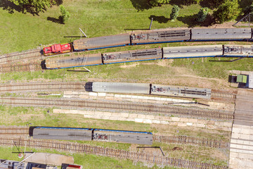 Wall Mural - aerial view of a train with locomotive on a railway track. trains at railroad yard at station district 