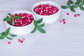 cranberries in two bowls. background with fresh cranberries. cranberries on the table close-up.