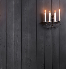 Wall Mural - candlestick with candles on a black wall