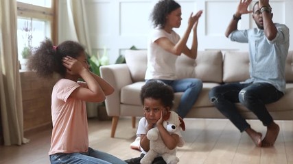 Wall Mural - African frightened children covered ears not to hear parents quarrel