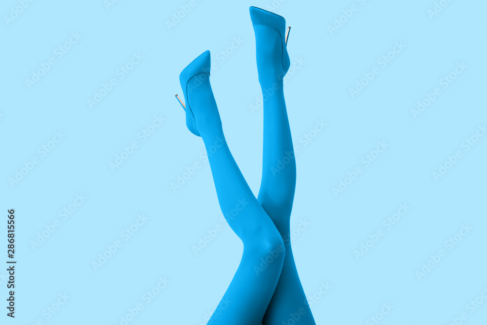 Legs of beautiful young woman in tights and high-heeled shoes on color background - obrazy, fototapety, plakaty 