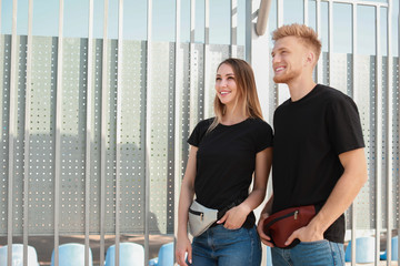 Wall Mural - Man and woman in stylish t-shirts outdoors