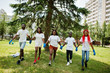 © AS Photo Family - Group of happy african volunteers hold hands together in park. Africa volunteering, charity, people and ecology concept.
