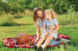 © Pixel-Shot - Happy mother and daughter at picnic outdoors