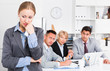 © JackF - Crying woman at office on background with coworkers