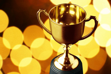 Wall Mural - shinny gold trophy with background night light bokeh , winner party concept.