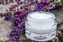 Natural Face Cream With Blue Lavender Wildflowers On A Wooden Background. Face Cream.