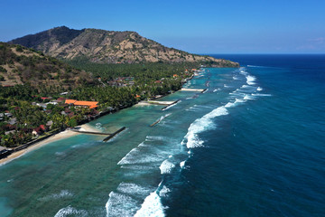 Canvas Print - Beautiful drone view of white sand beach and a calm resorts of Candi Dasa, East Bali.