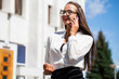 © Andrey_Arkusha - Young brunette woman calling by phone