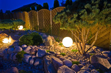 Home Garden At Night, Illuminated By Globe Shaped Lights