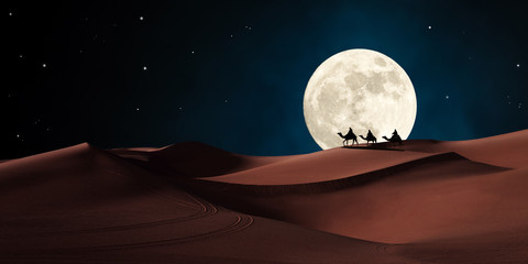 Three wise men riding on camels traveling in the desert