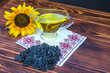 wooden background with sunflower oil, seeds and a sunflower