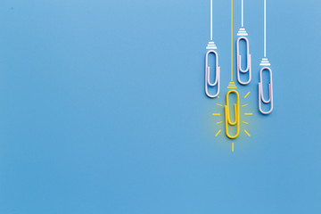 Great ideas concept with paperclip,thinking,creativity,light bulb on blue background,new ideas concept.