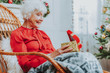 © Yakobchuk Olena - Happy old woman is holding gift box