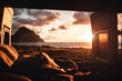 Blick vom Bett aus dem Camper Van auf Landschaft mit Meer und Berg bei Sonnenuntergang