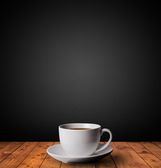 Wall Mural - Cup of drink on wooden table with dark background