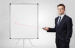 © ra2 studio - Young businessman with laser pointer and copyspace white blackboard