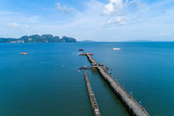 Fototapeta Krajobraz - Aerial high angle view drone shot of pier with long tail boats fisherman in summer season beautiful landscape view image from drone