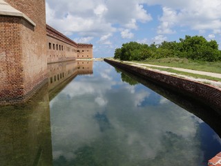 Wall Mural - Fort Jefferson reflected in the moat at the Dry Tortugas National Park in Florida.