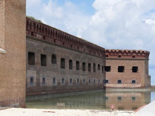 Wall Mural - Moat on one side of Fort Jefferson, with warning signs in the banks.