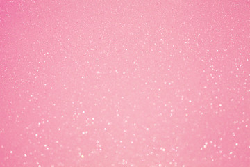 Glowing blurred festive pink shiny background, perfect backdrop for greeting christmas cards and text