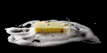 Soap Foam With Bubbles And Sponge Isolated On Black Background