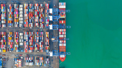 Container ship loading and unloading in deep sea port, Aerial top view of business logistic import and  export freight  transportation by container ship in open sea.