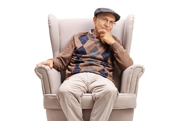 Sticker - Elderly man sitting in an armchair and thinking