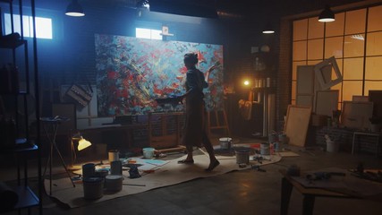 Fototapete - Talented Female Artist Working on a Modern Abstract Oil Painting, Uses Splattering and Dripping with Paint Brush Technique. Dark Creative Studio Large Picture Stands on Easel Illuminated. Slow Motion
