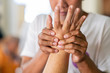 © Jack Tamrong - Hands of man doing Thai traditional hand massage at middle finger and pressing at specific spots, health and wellness concept.