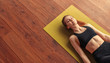 Peaceful woman meditating while lying down on floor