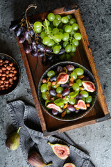 Wall Mural - Fruit salad with green and red grapes, jumbo golden raisins, figs and hazelnuts