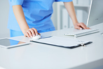 portrait of a female doctor using her laptop computer at clinic