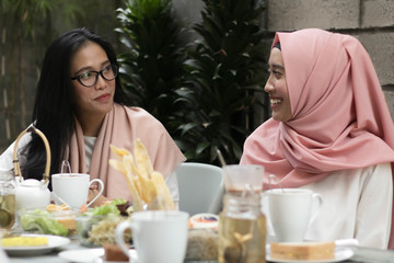 Wall Mural - women having conversation in middle of lunch