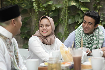 Wall Mural - group of happy young muslim having dinner outdoor