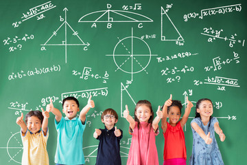 Wall Mural - happy Multi-ethnic group of school children standing in classroom with math concept