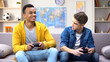 © motortion - Emotional multiracial male teen friends playing video game, hobby and rivalry