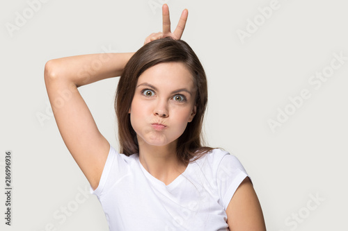 Cuadros en Lienzo Funny millennial girl have fun grimacing in studio