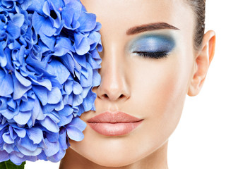 Wall Mural - closeup face of young beautiful woman with a blue makeup of eyes.