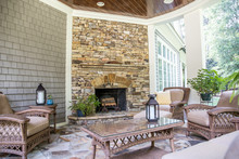 Back Stone Patio Porch Of Large Home With An Outdoor Fireplace