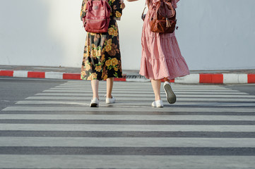 women tourist walk together a crossing the zebra crossing way in city