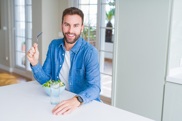 Wall Mural - Handsome man eating green peas at home