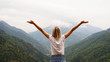© brillianata - Cheering woman hiker open arms at mountain peak - nature and lifestyle