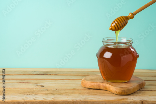 Jewish holiday Rosh Hashana background with honey jar on wooden table Poster Mural XXL