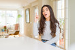 © Krakenimages.com - Young beautiful woman at home pointing finger up with successful idea. Exited and happy. Number one.