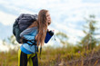© Андрей Репетий - Young girl hiker with long hair with backpack going up hiking trail