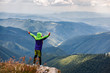 © Андрей Репетий - Young traveler standing on the peak of mountain feeling freedom. Dramatic picture.