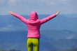 © Андрей Репетий - Woman hiker standing with hands up achieving the top of mountain admiring the feeling of freedom and success.