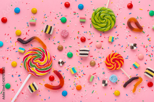 flat lay of candies festive background with assortment of colourful caramel w...