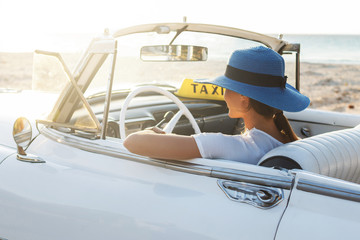 Poster - Happy young woman and retro convertible car